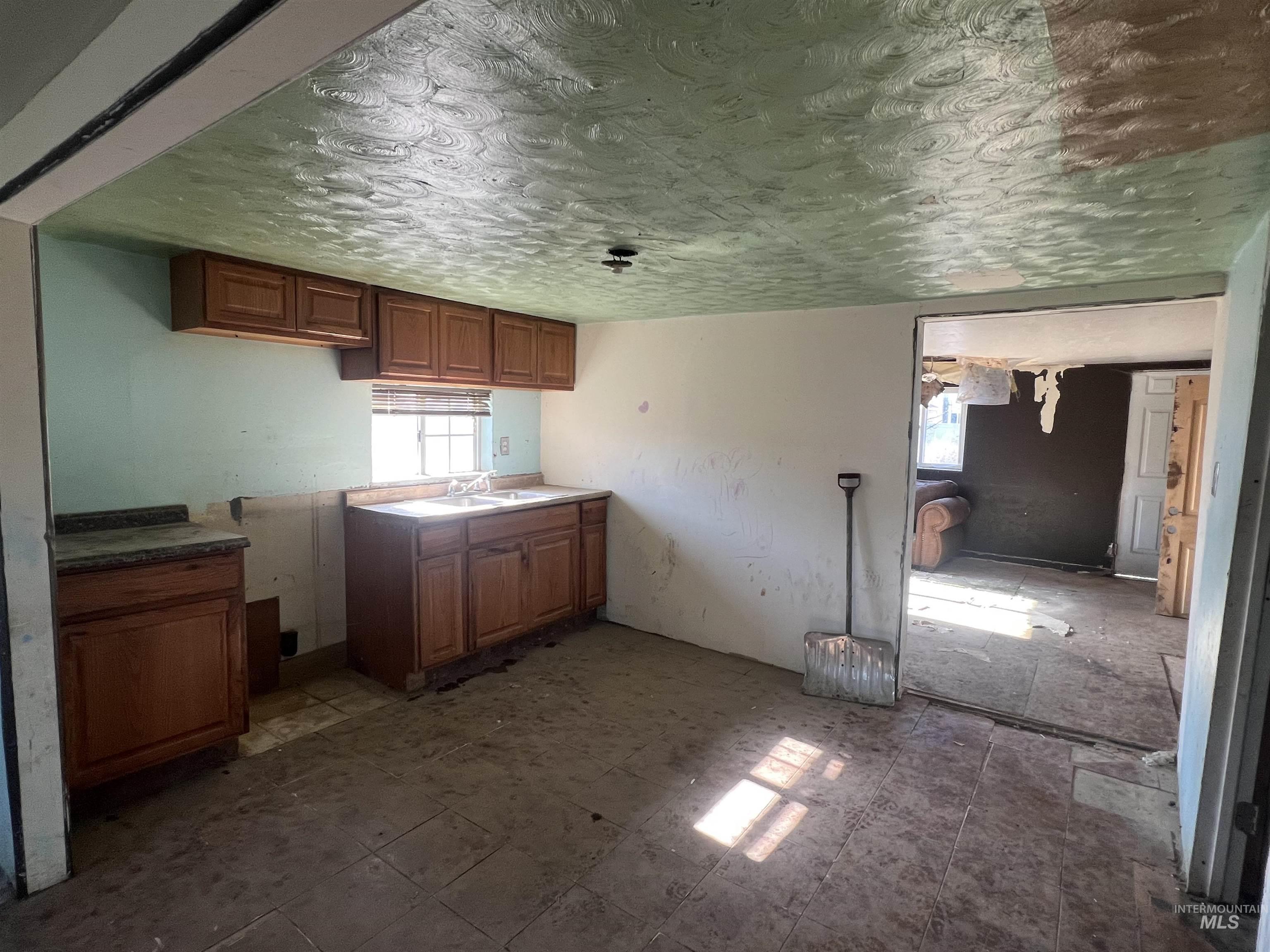 717 North 3rd Street Nyssa, OR 97913 - Photo 8 of 12 Kitchen featuring wood finish cabinetry and a textured ceiling