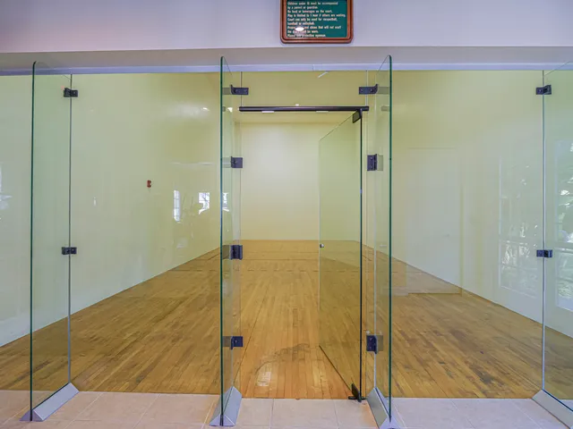 a bathroom with a shower and a glass door