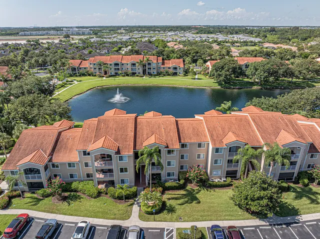 an aerial view of residential houses with outdoor space and lake view