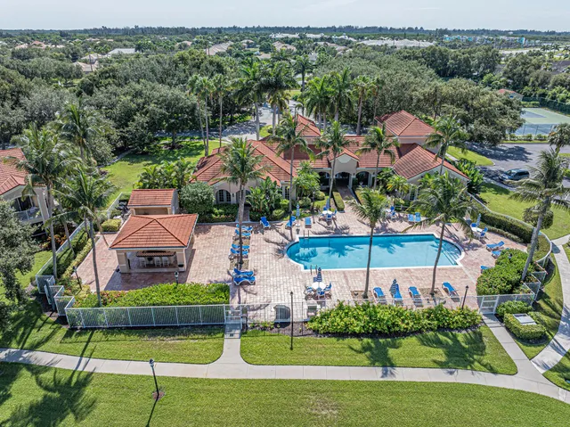 an aerial view of house with swimming pool outdoor seating and yard