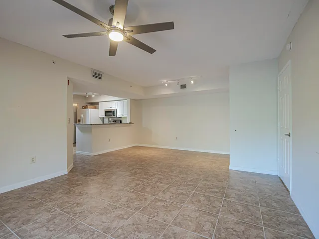 a view of a kitchen with a sink and a refrigerator