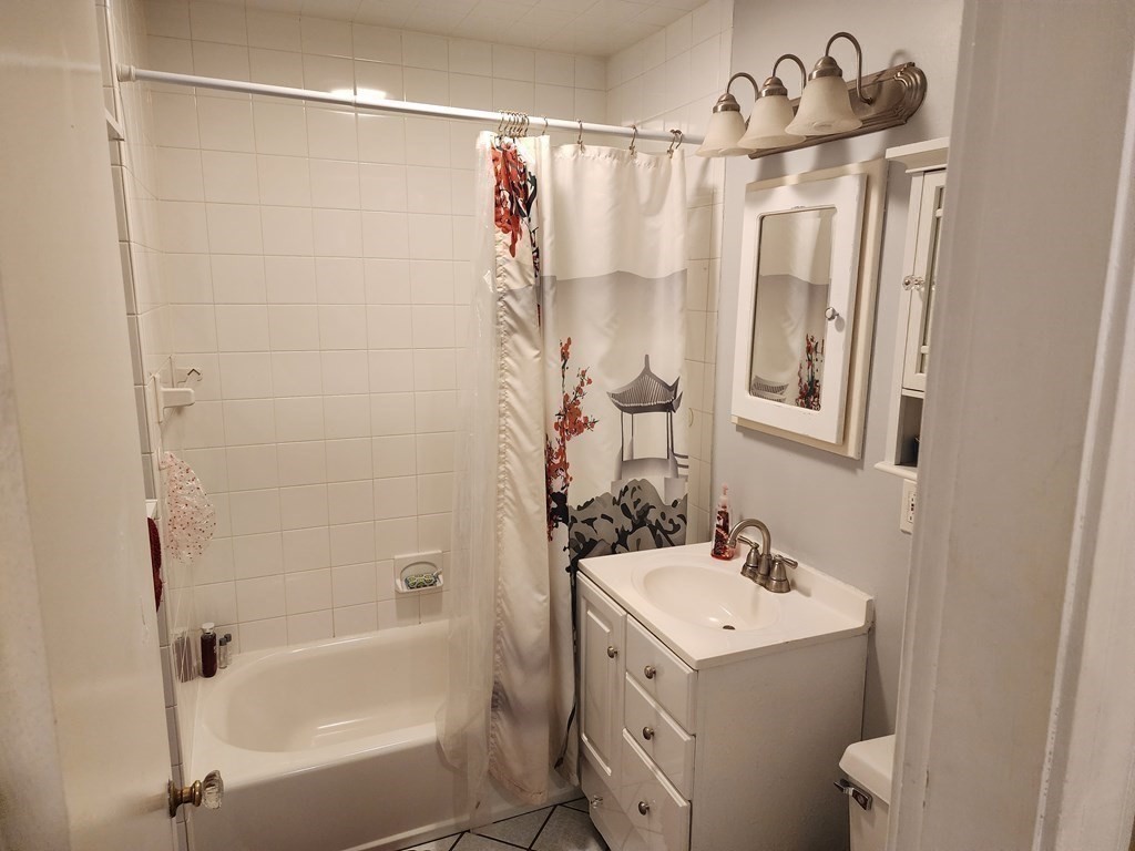 67 Sylvan Road Lancaster, MA 01523 - Photo 19 of 33 a bathroom with a sink mirror toilet and bathtub
