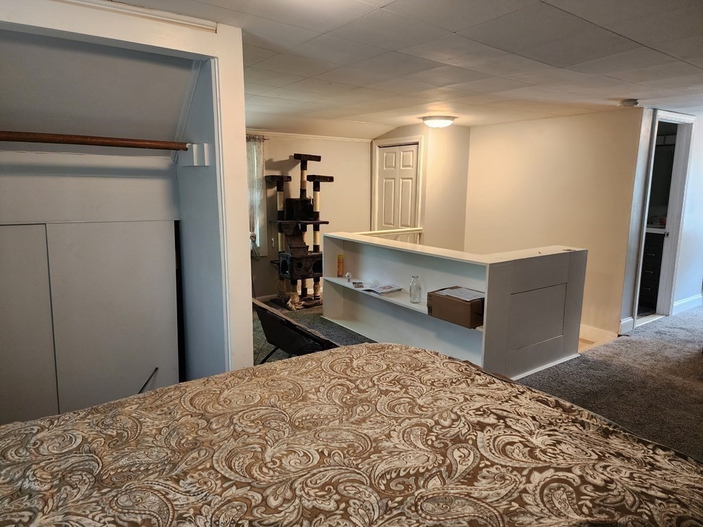 67 Sylvan Road Lancaster, MA 01523 - Photo 22 of 33 a bedroom with a bed and a refrigerator