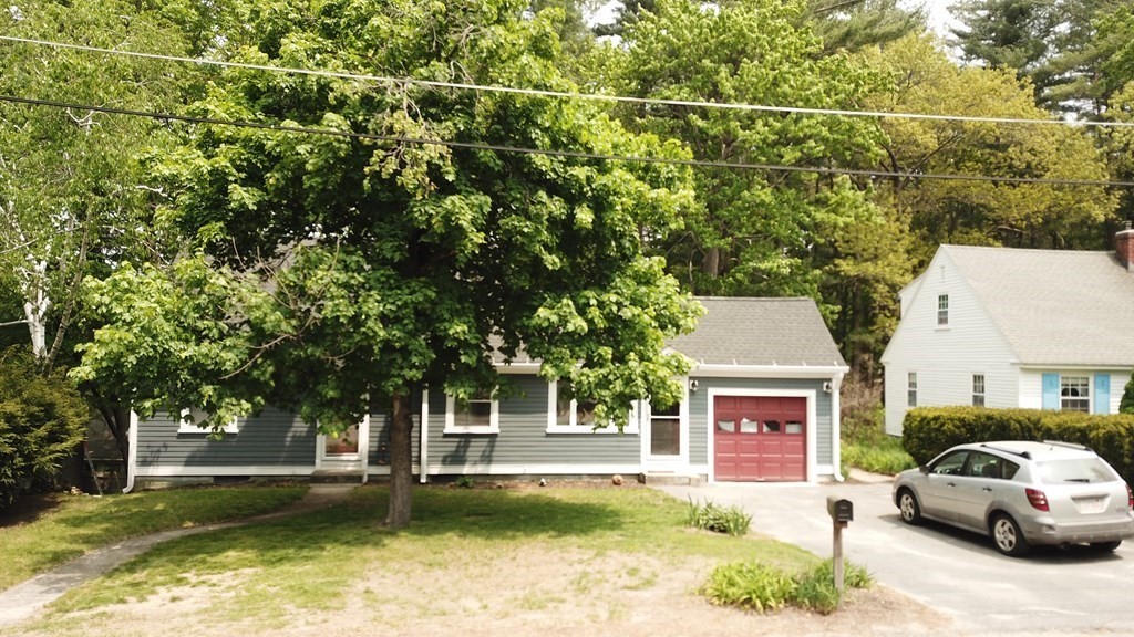 67 Sylvan Road Lancaster, MA 01523 - Photo 33 of 33 a view of a house with pool and trees in the background