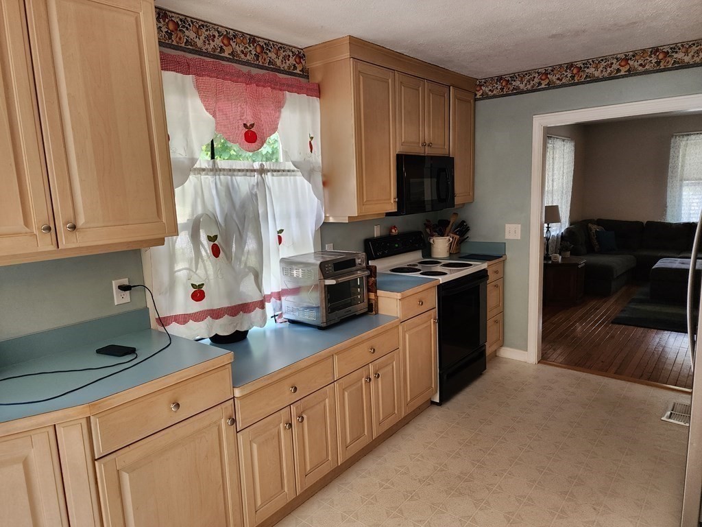 67 Sylvan Road Lancaster, MA 01523 - Photo 6 of 33 a kitchen with stainless steel appliances a stove a sink and a microwave
