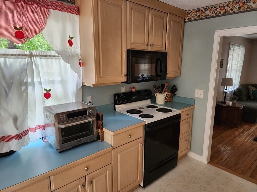 67 Sylvan Road Lancaster, MA 01523 - Photo 7 of 33 a kitchen with a stove and a microwave