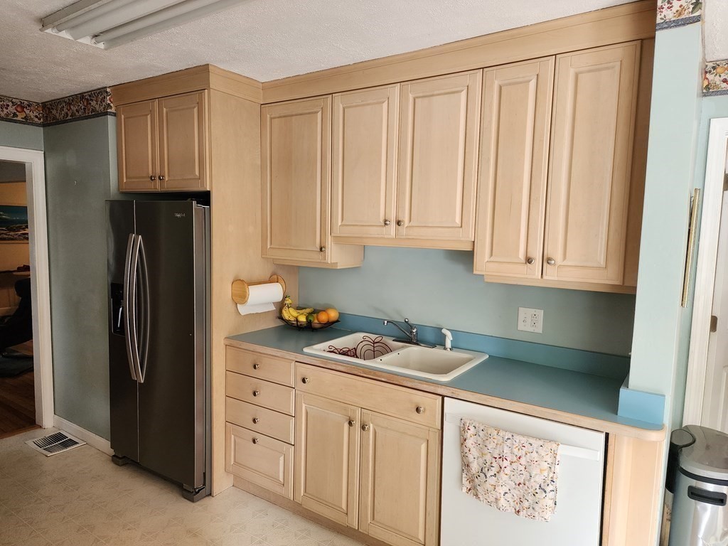 67 Sylvan Road Lancaster, MA 01523 - Photo 8 of 33 a kitchen with stainless steel appliances granite countertop a refrigerator sink and cabinets