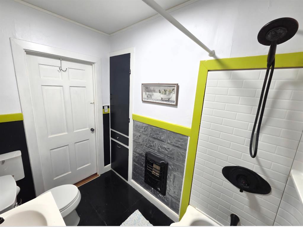 313 King Street Eden, TX 76837 - Photo 13 of 24 a bathroom with a toilet and a shower