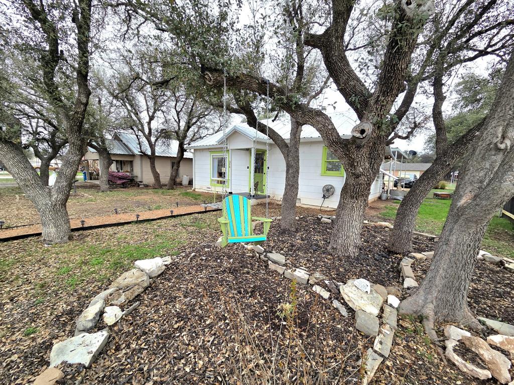 313 King Street Eden, TX 76837 - Photo 2 of 24 a white house that has a tree in front of the house