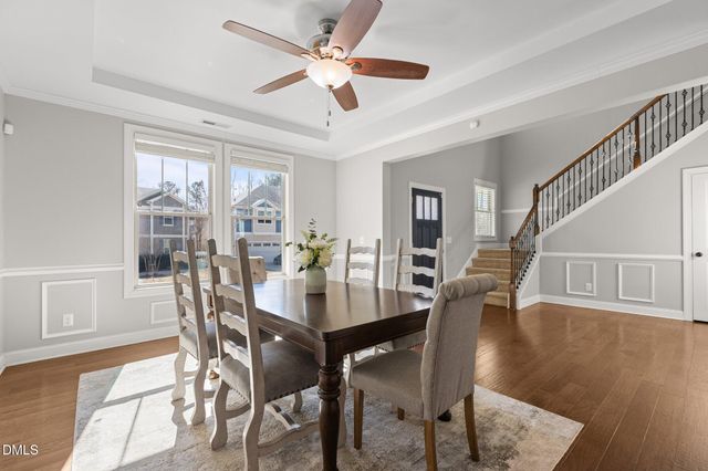a view of entryway with wooden floor and dining room