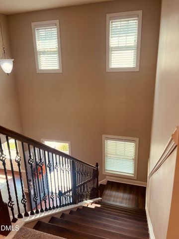 a open kitchen with stainless steel appliances granite countertop a sink dishwasher a refrigerator and a dining table with wooden floor