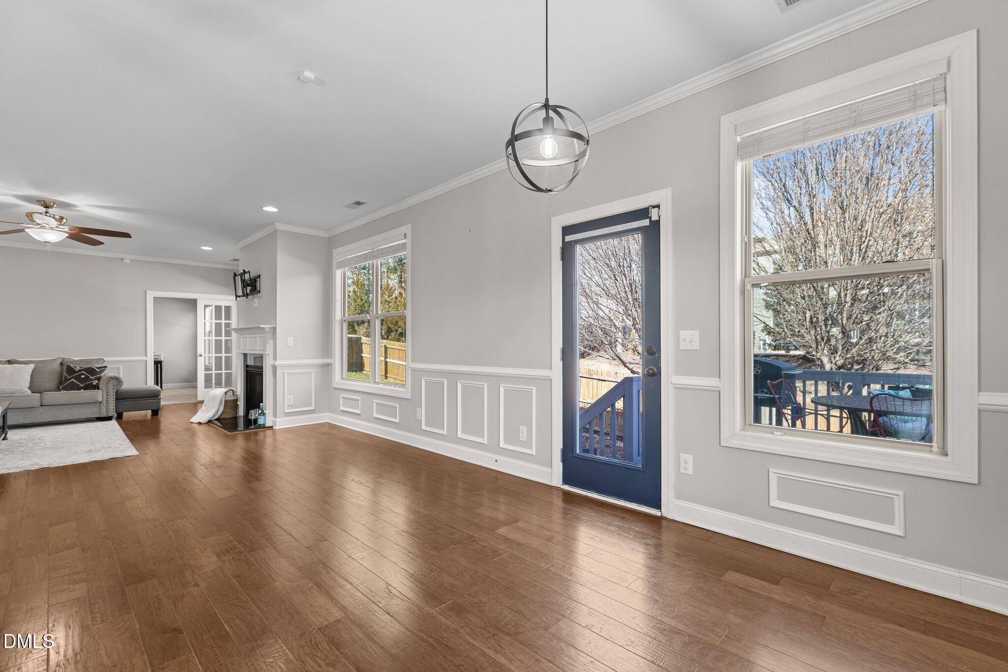 104 Highland Mist Circle Apex, NC 27539 - Photo 15 of 49 a view of an empty room with wooden floor and windows