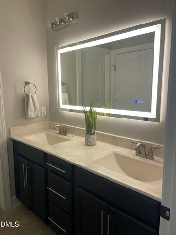 an empty room with a chandelier fan