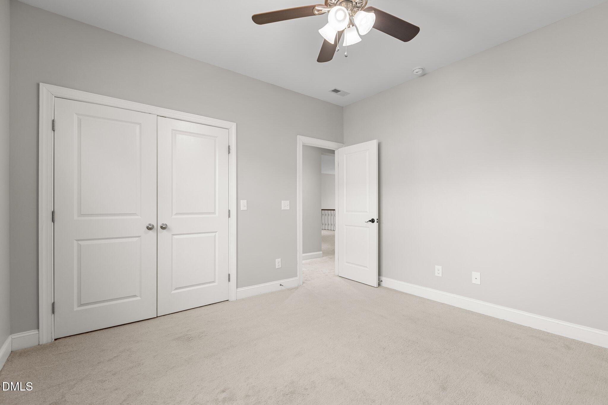 104 Highland Mist Circle Apex, NC 27539 - Photo 30 of 49 an empty room with a chandelier fan