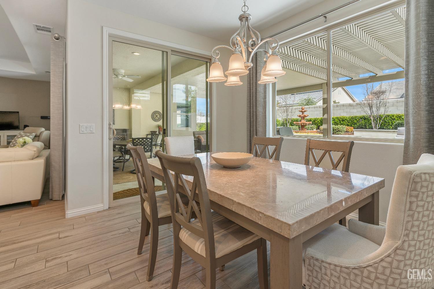 Undisclosed Address Bakersfield, CA 93311 - Photo 11 of 25 a view of a dining room with furniture wooden floor and chandelier