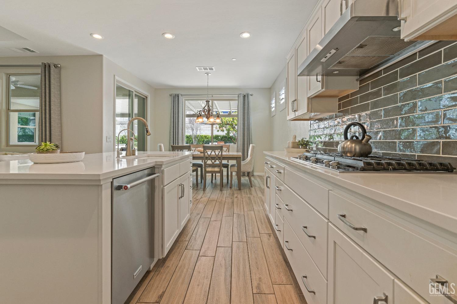 Undisclosed Address Bakersfield, CA 93311 - Photo 12 of 25 a kitchen with counter top space a sink appliances and cabinets