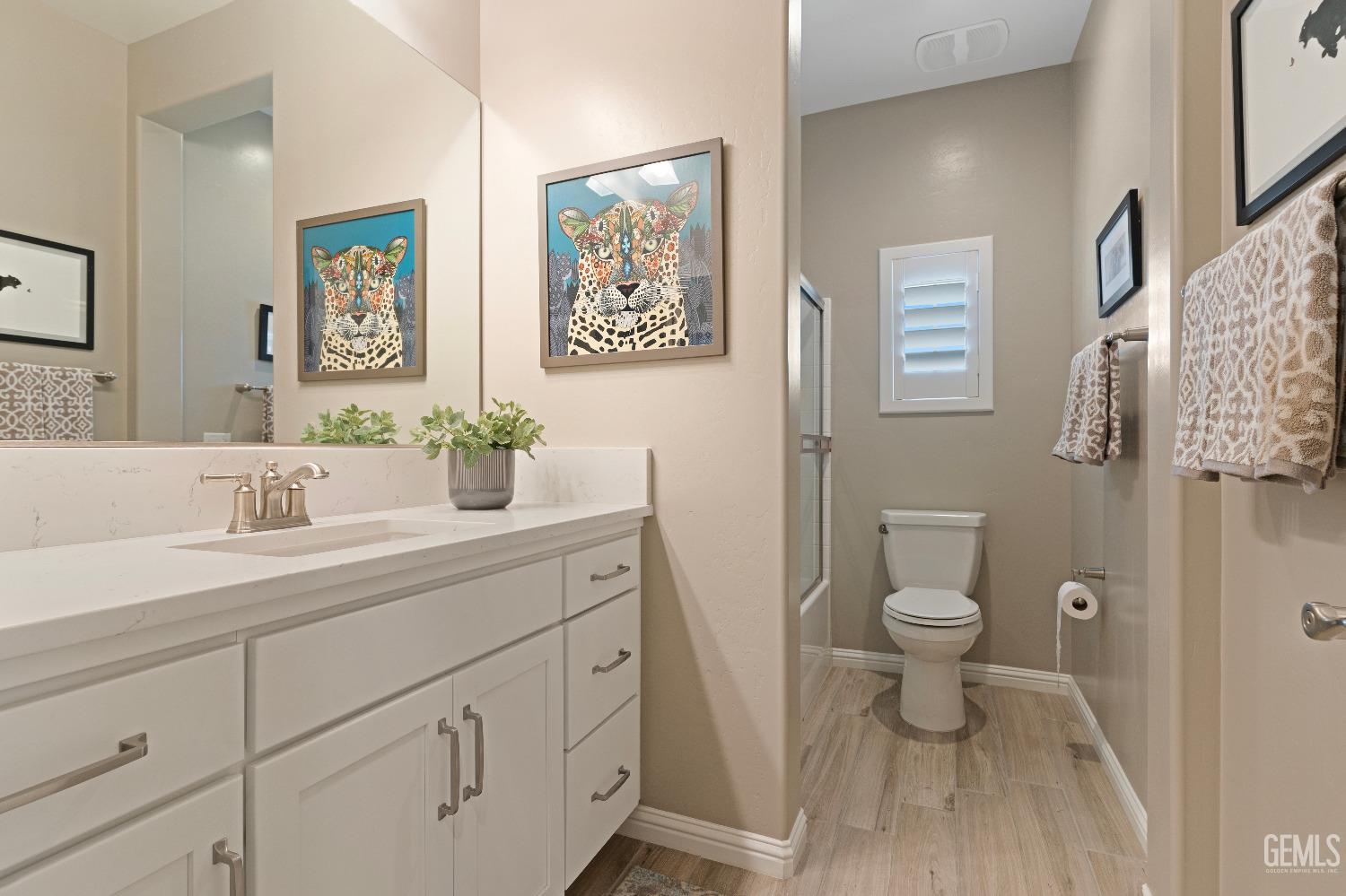 Undisclosed Address Bakersfield, CA 93311 - Photo 15 of 25 a bathroom with a toilet a sink and mirror