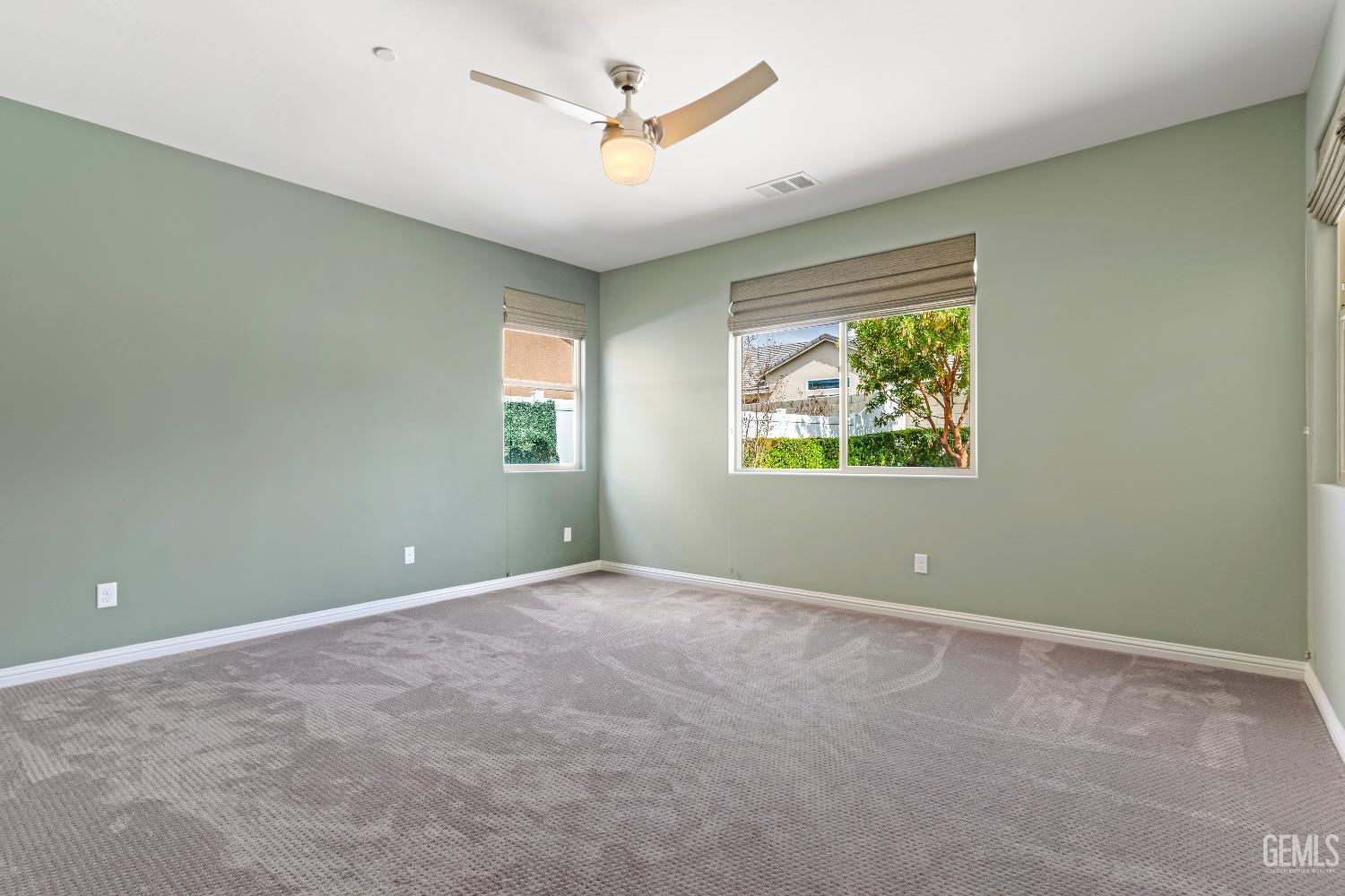 Undisclosed Address Bakersfield, CA 93311 - Photo 17 of 25 a view of an empty room with a window and a ceiling fan