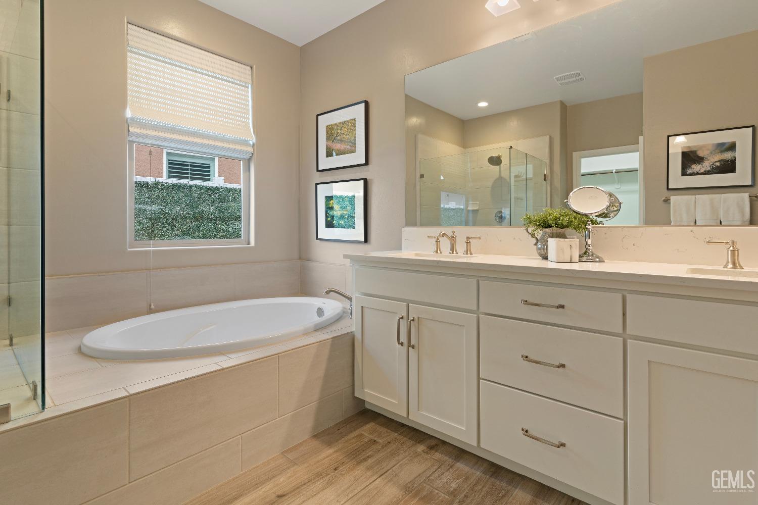 Undisclosed Address Bakersfield, CA 93311 - Photo 18 of 25 a bathroom with a granite countertop sink mirror and bathtub