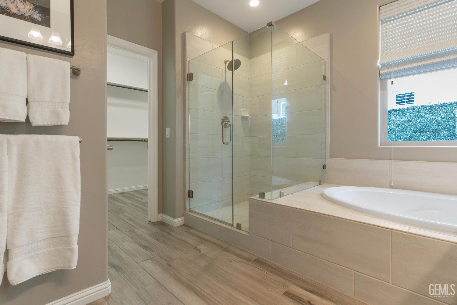Undisclosed Address Bakersfield, CA 93311 - Photo 19 of 25 a spacious bathroom with a shower and a bathtub