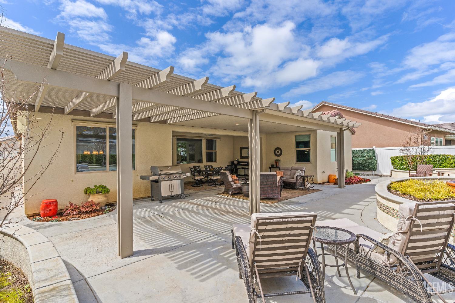 Undisclosed Address Bakersfield, CA 93311 - Photo 25 of 25 a view of a patio with couches and table and chairs and potted plants