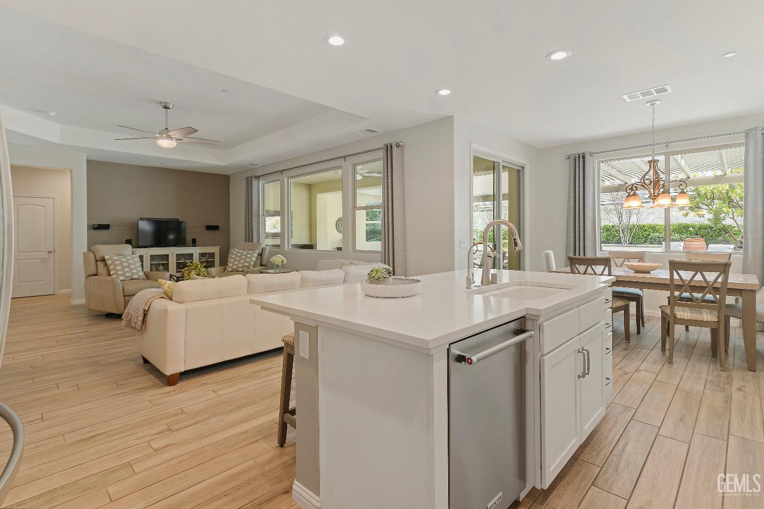 Undisclosed Address Bakersfield, CA 93311 - Photo 6 of 25 a kitchen with kitchen island granite countertop a sink stove and wooden floor