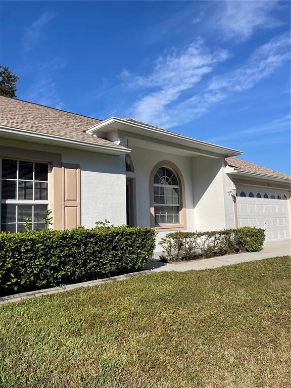 9311 Villa Entrada New Port Richey, FL 34655 - Photo 14 of 16 a front view of a house with a garden