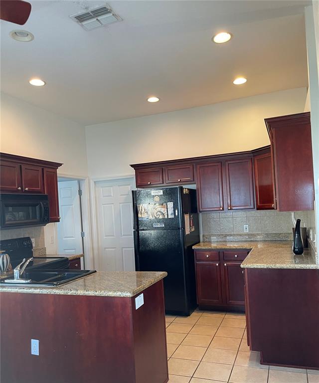 9311 Villa Entrada New Port Richey, FL 34655 - Photo 2 of 16 a kitchen with granite countertop a refrigerator and a sink