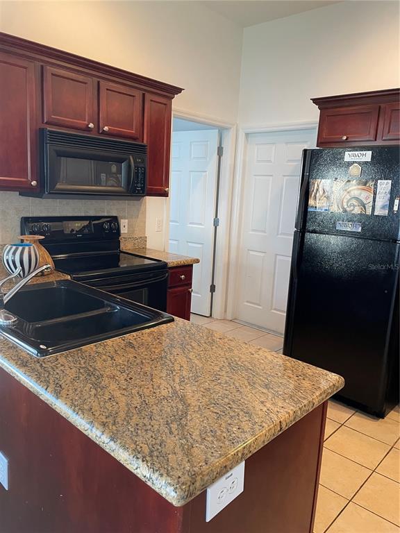 9311 Villa Entrada New Port Richey, FL 34655 - Photo 3 of 16 a kitchen with stainless steel appliances granite countertop a sink stove and refrigerator