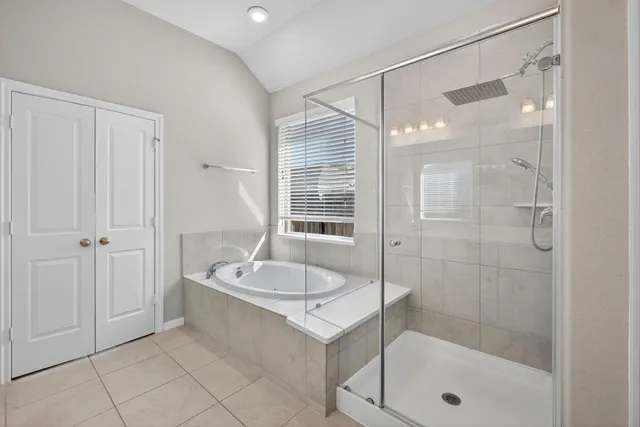 a spacious bathroom with a double vanity sink and a mirror