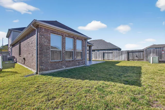 an aerial view of a house with a garden and swimming pool