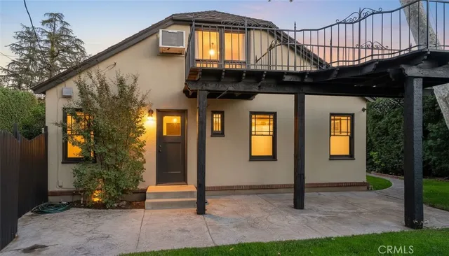 a front view of a house with lots of trees
