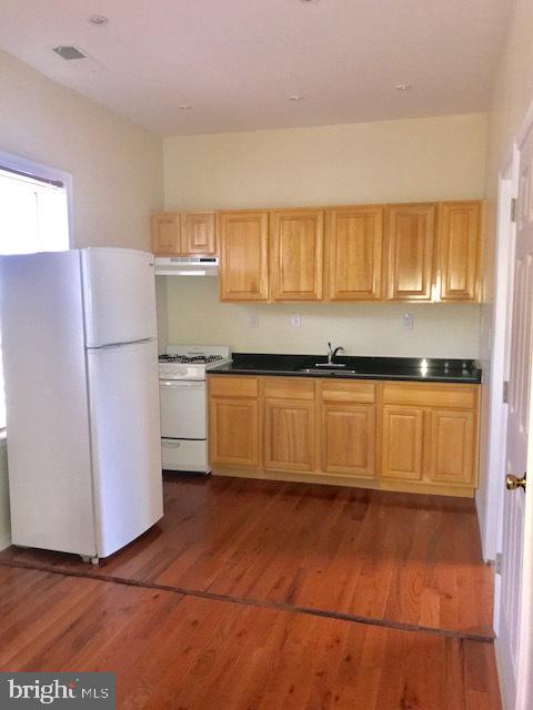 767 South 4th Street, Unit 3 Philadelphia, PA 19147 - Photo 5 of 10 a kitchen with a refrigerator and a more cabinets