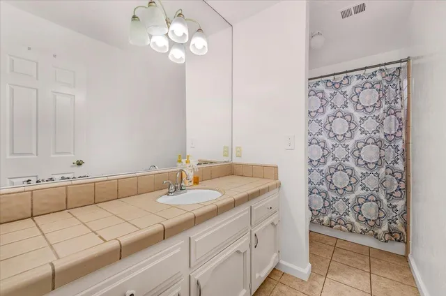 a bathroom with a sink a vanity and a mirror