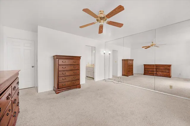 a view of an empty room with a ceiling fan