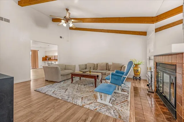 a living room with furniture a fireplace and a window