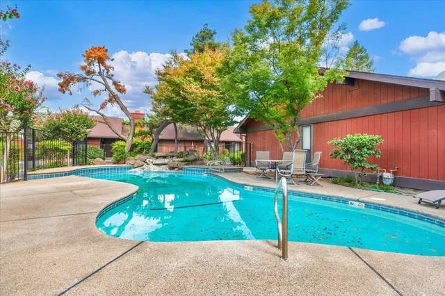 a view of a house with a yard and sitting area
