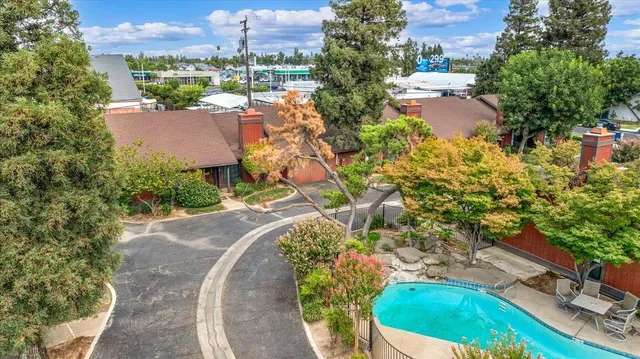 an aerial view of a house with a yard and lake view