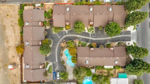 an aerial view of house with yard and swimming pool