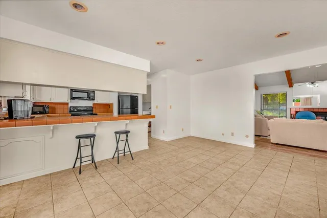 a view of kitchen with furniture and refrigerator