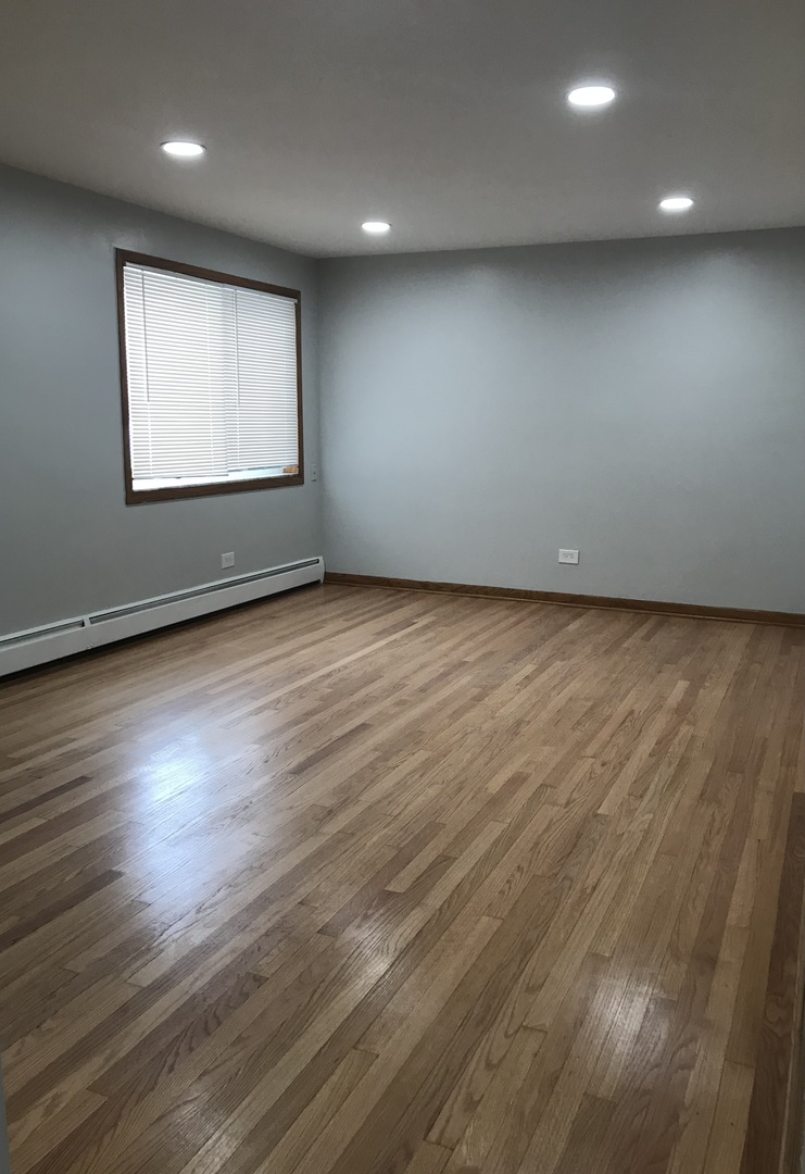 6854 Cermak Road, Unit GC Berwyn, IL 60402 - Photo 2 of 9 an empty room with wooden floor and windows