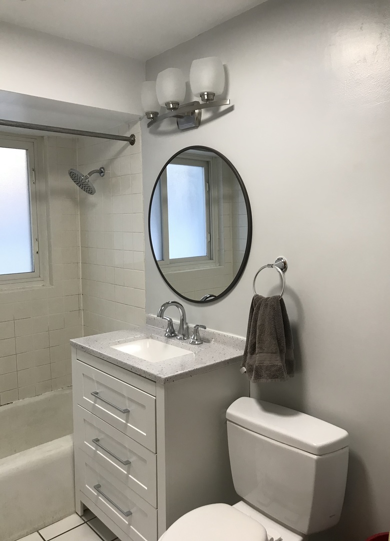 6854 Cermak Road, Unit GC Berwyn, IL 60402 - Photo 7 of 9 a bathroom with a granite countertop toilet sink and mirror