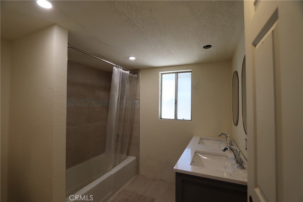 10354 Mulberry Street Middletown, CA 95461 - Photo 16 of 18 a bathroom with a sink a shower and a mirror