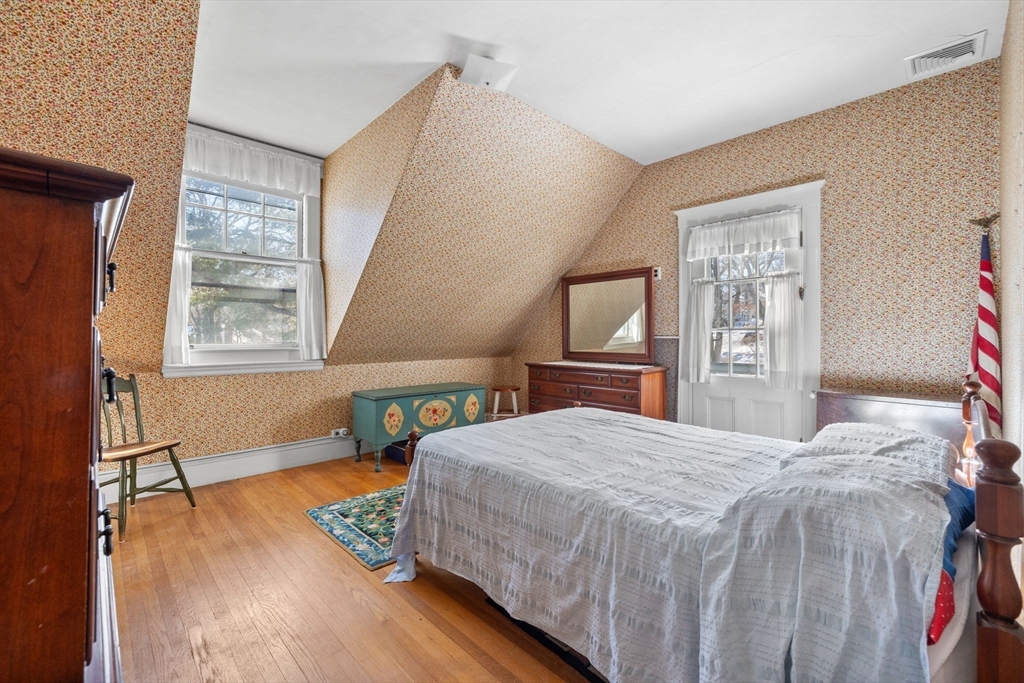 27 Locust Avenue Lexington, MA 02421 - Photo 15 of 38 a bedroom with a bed windows and wooden floor
