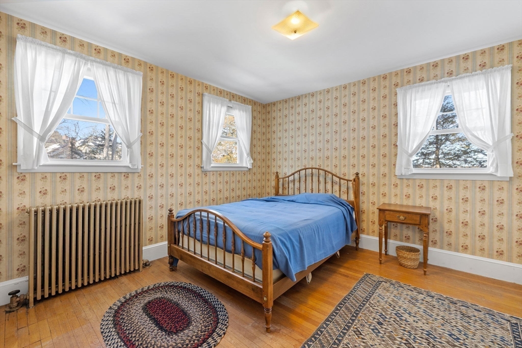 27 Locust Avenue Lexington, MA 02421 - Photo 19 of 38 a bedroom with a bed and wooden floor