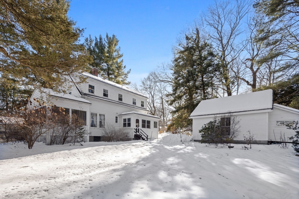27 Locust Avenue Lexington, MA 02421 - Photo 27 of 38 a view of a white house with a yard covered in snow