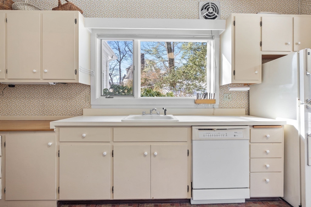 27 Locust Avenue Lexington, MA 02421 - Photo 8 of 38 a kitchen with white cabinets and a large window