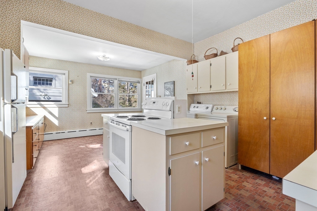 27 Locust Avenue Lexington, MA 02421 - Photo 9 of 38 a kitchen with stainless steel appliances granite countertop a stove a sink and a refrigerator