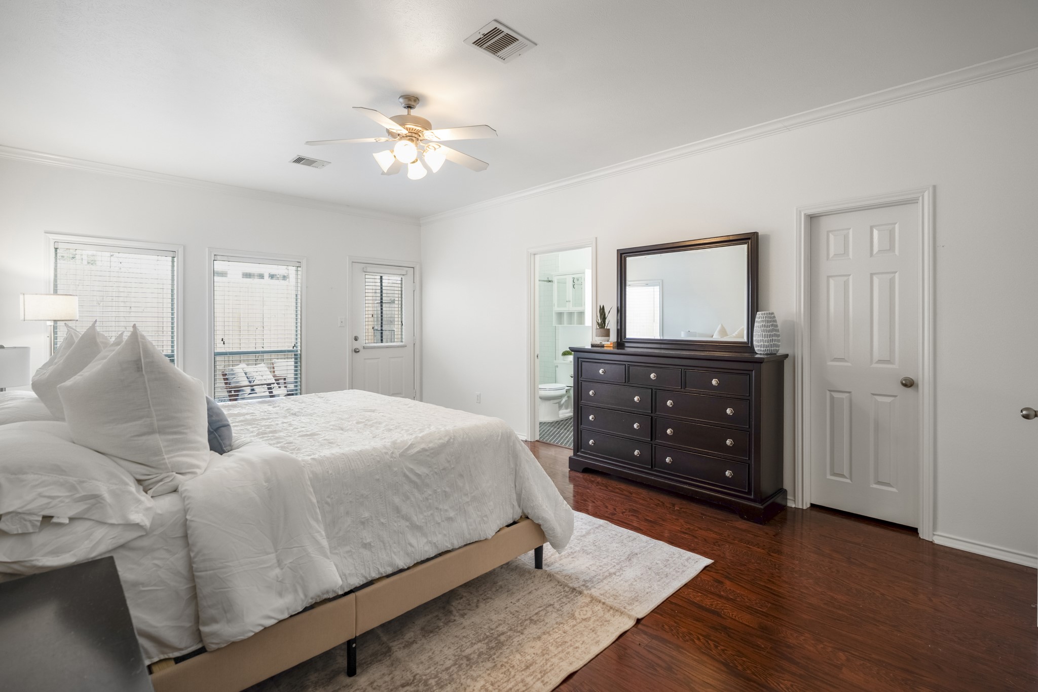 3209 Chenevert Street Houston, TX 77004 - Photo 15 of 32 Spacious primary bedroom retreat offering a peaceful escape within this centrally located Midtown Houston townhome, with ample space for a king-size bed and additional seating or workspace.
