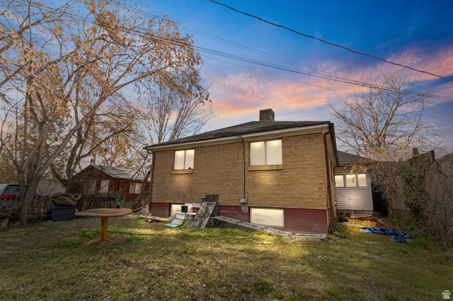 386 North 500 East Provo, UT 84606 - Photo 24 of 24 Rear view of house featuring a lawn and brick siding